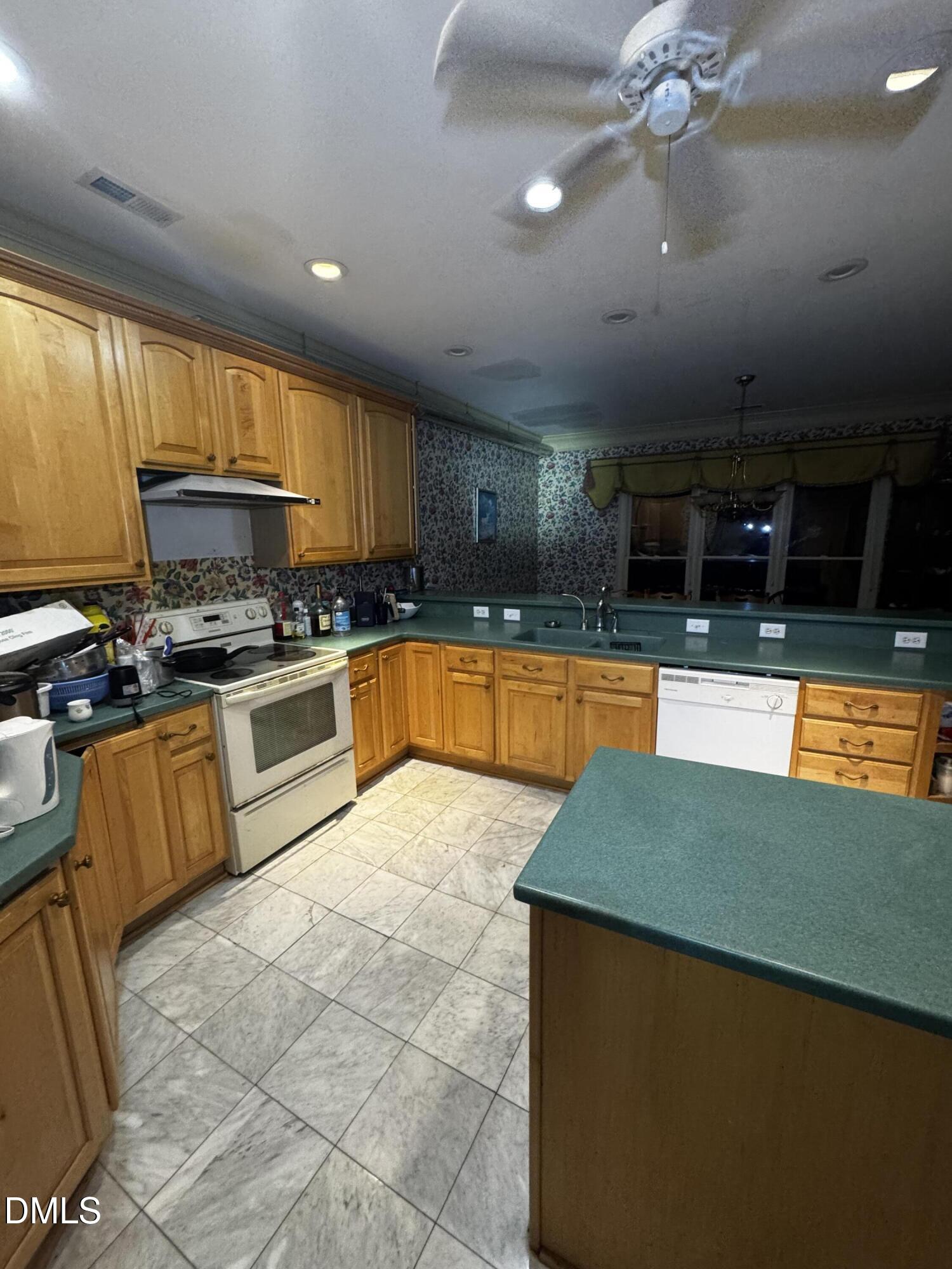 6508 Litchford Road Raleigh, NC 27615 - Photo 5 of 17 a kitchen with stainless steel appliances granite countertop a sink counter space cabinets and a large window