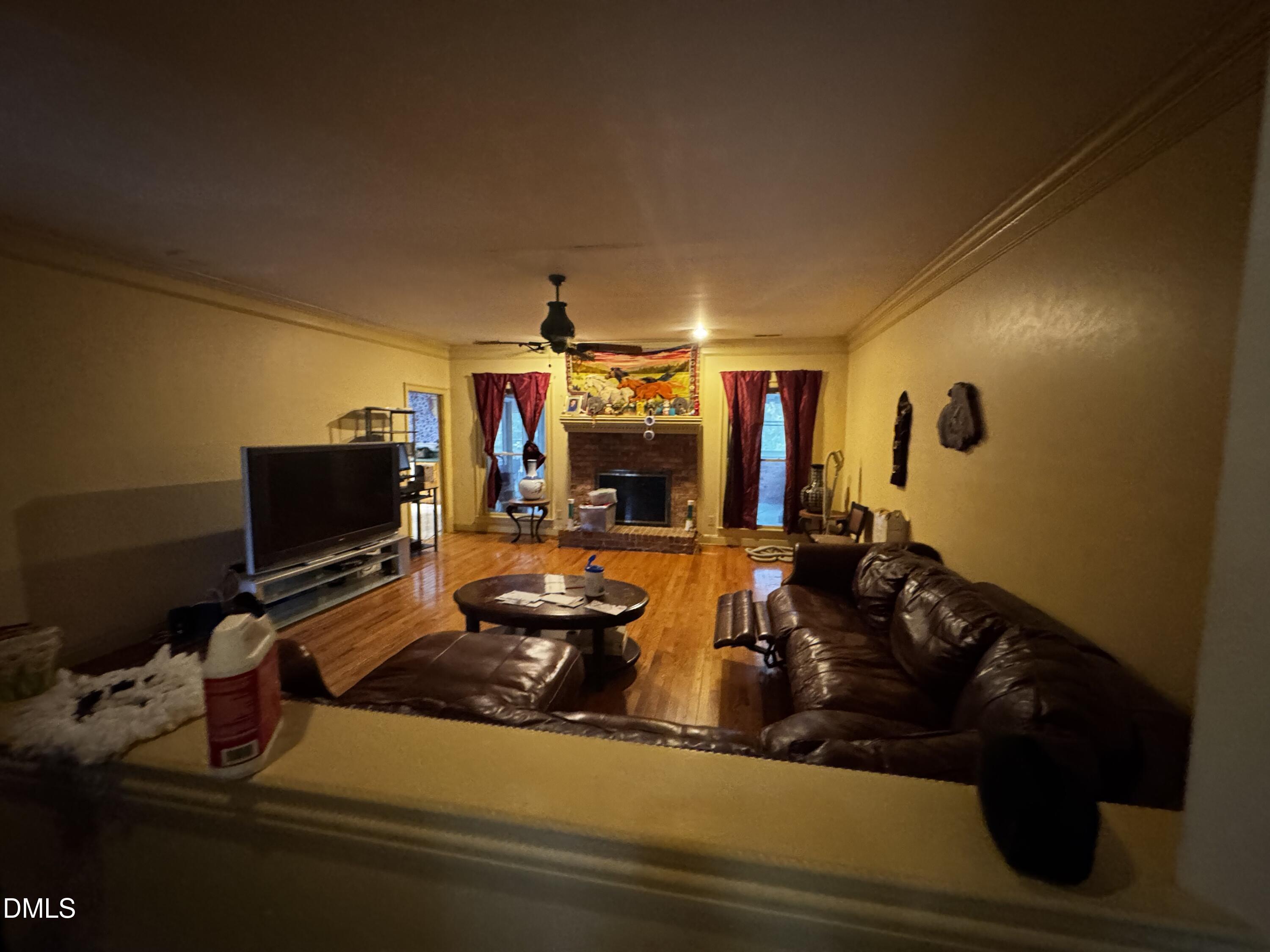 6508 Litchford Road Raleigh, NC 27615 - Photo 8 of 17 a living room with furniture and a flat screen tv