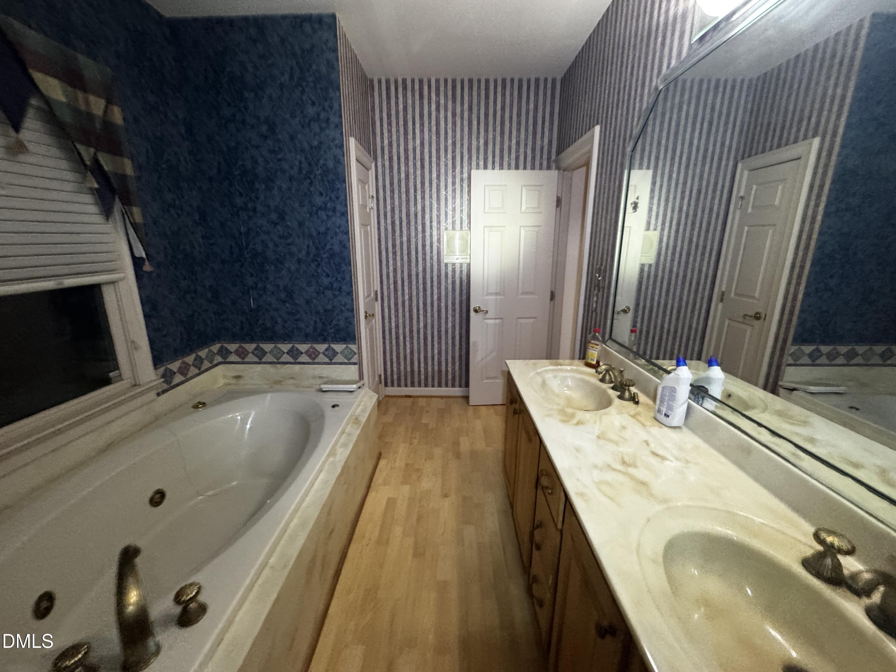 6508 Litchford Road Raleigh, NC 27615 - Photo 10 of 17 a bathroom with a granite countertop sink a mirror and shower