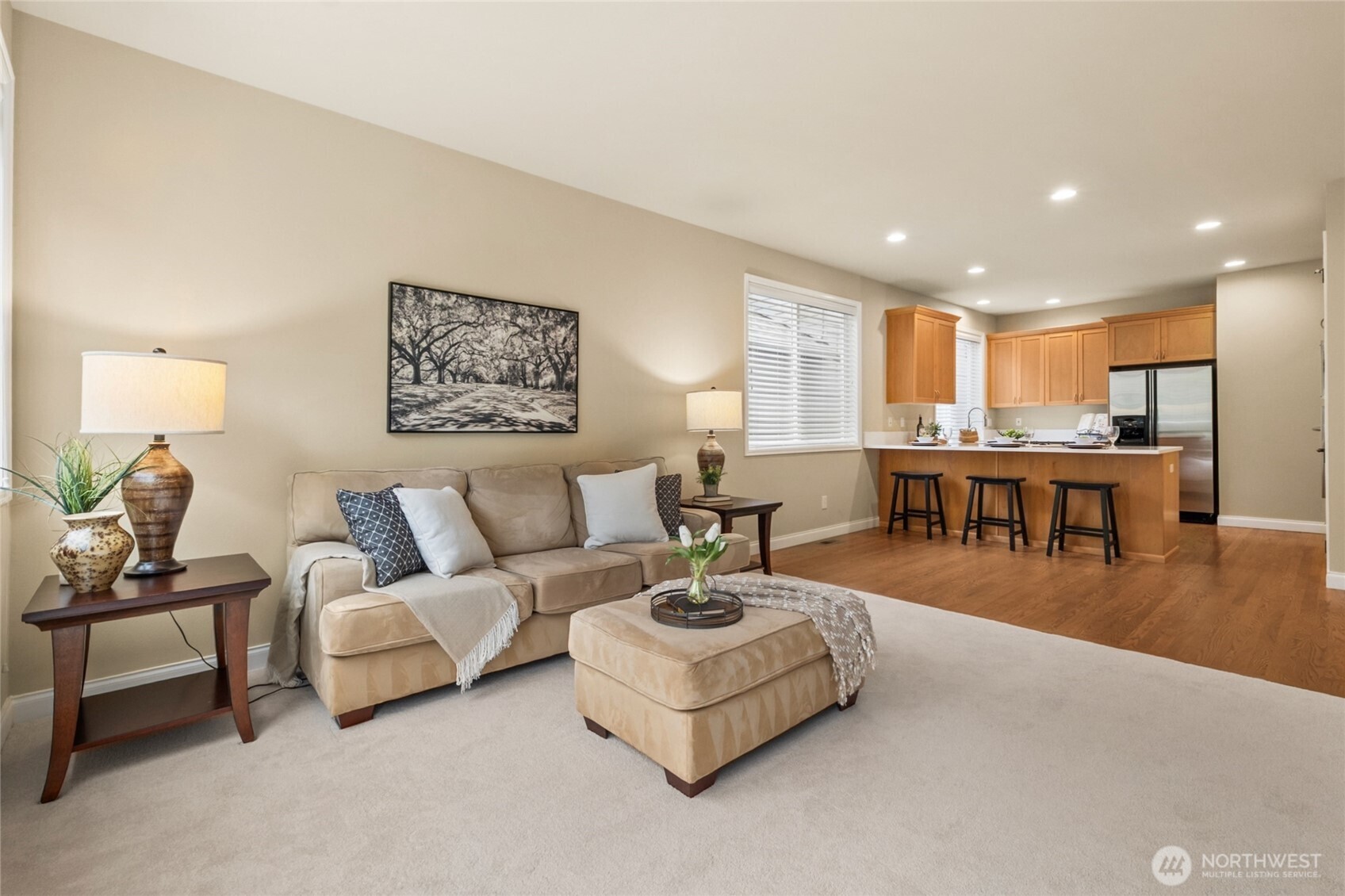 6701 West Crestview Loop Southeast Snoqualmie, WA 98065 - Photo 12 of 40 a living room with furniture and a table with kitchen view