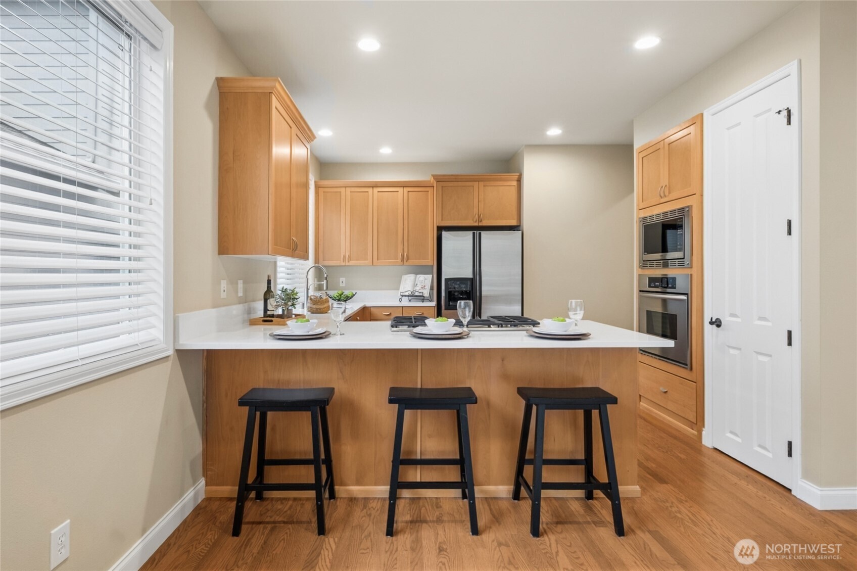 6701 West Crestview Loop Southeast Snoqualmie, WA 98065 - Photo 13 of 40 a kitchen with a table and chairs in it