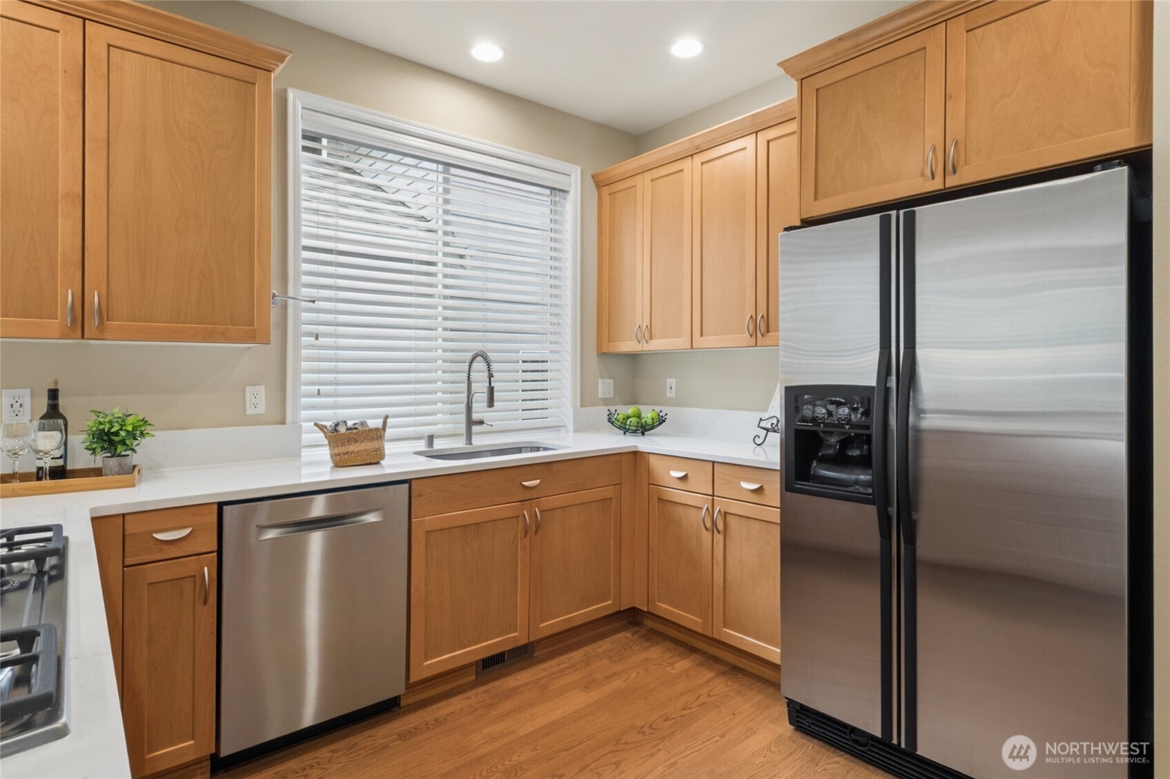 6701 West Crestview Loop Southeast Snoqualmie, WA 98065 - Photo 14 of 40 a kitchen with stainless steel appliances granite countertop a refrigerator a sink and dishwasher
