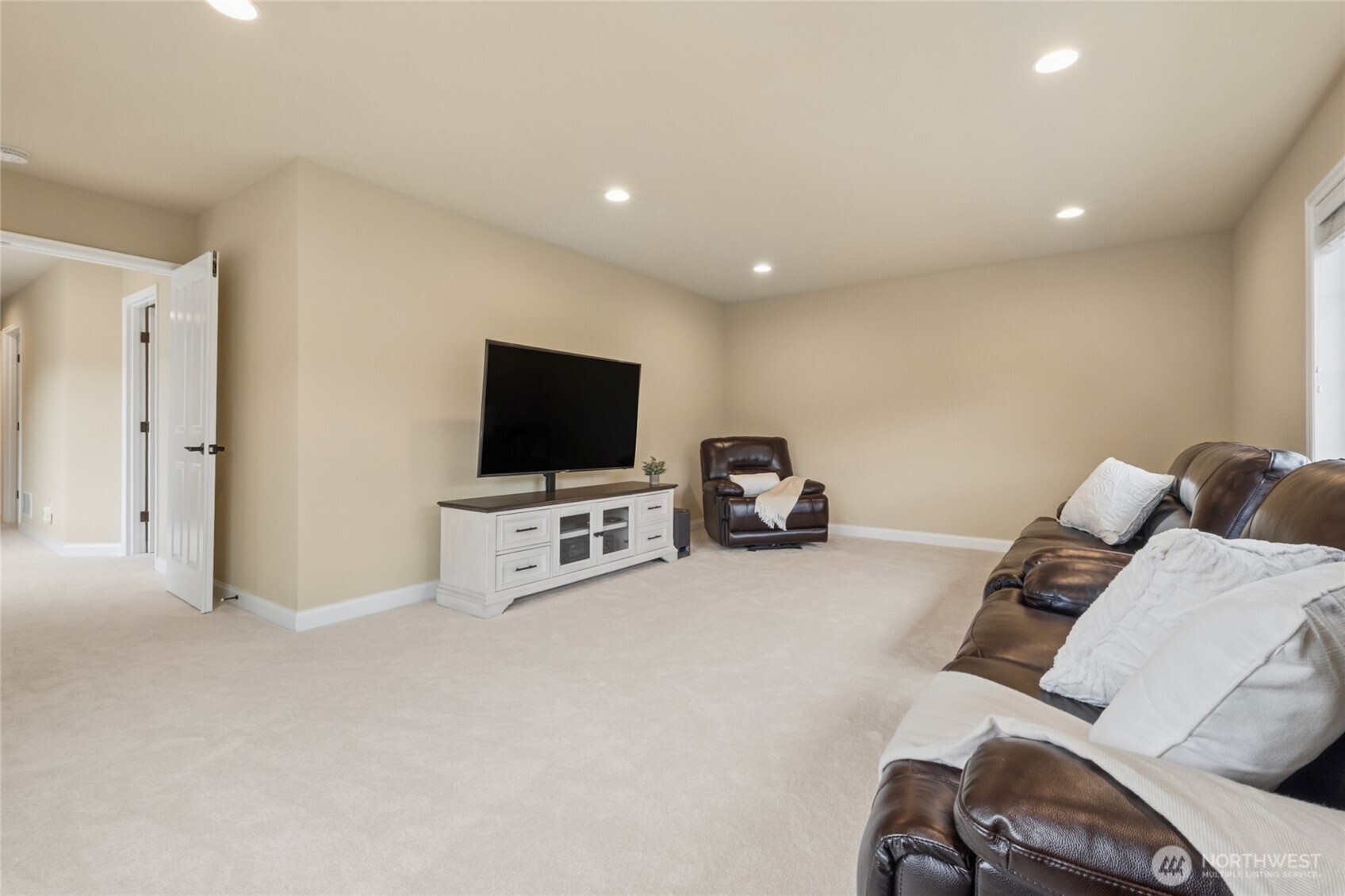 6701 West Crestview Loop Southeast Snoqualmie, WA 98065 - Photo 29 of 40 a living room with furniture and a flat screen tv