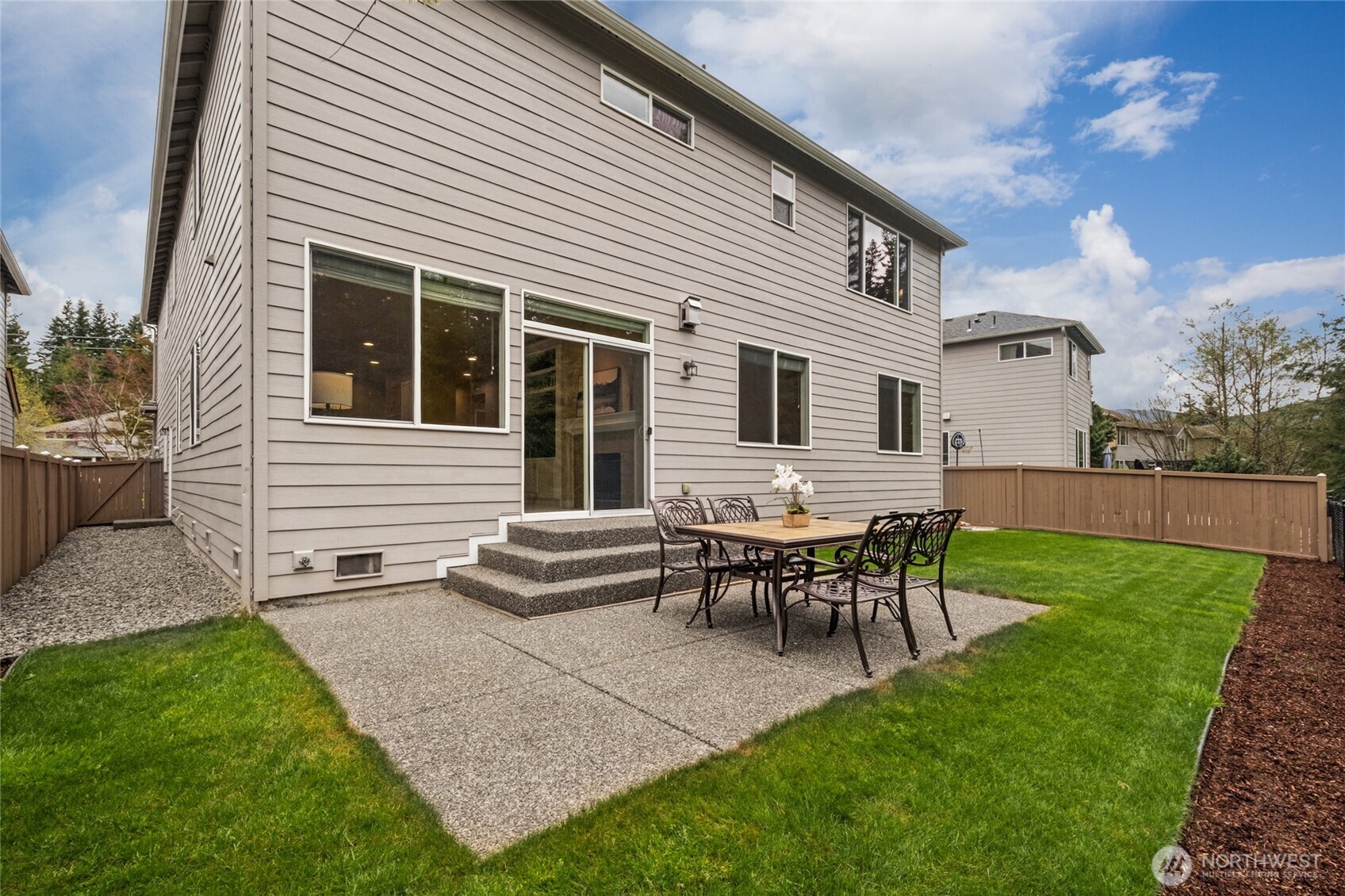 6701 West Crestview Loop Southeast Snoqualmie, WA 98065 - Photo 32 of 40 a backyard of a house with table and chairs