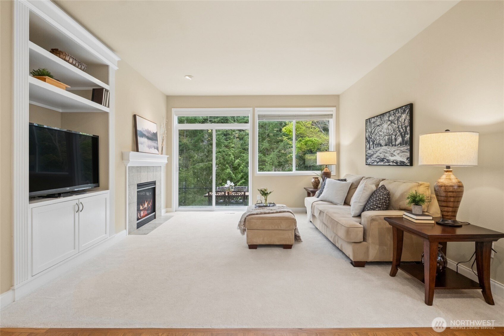 6701 West Crestview Loop Southeast Snoqualmie, WA 98065 - Photo 10 of 40 a living room with furniture a flat screen tv and a large window
