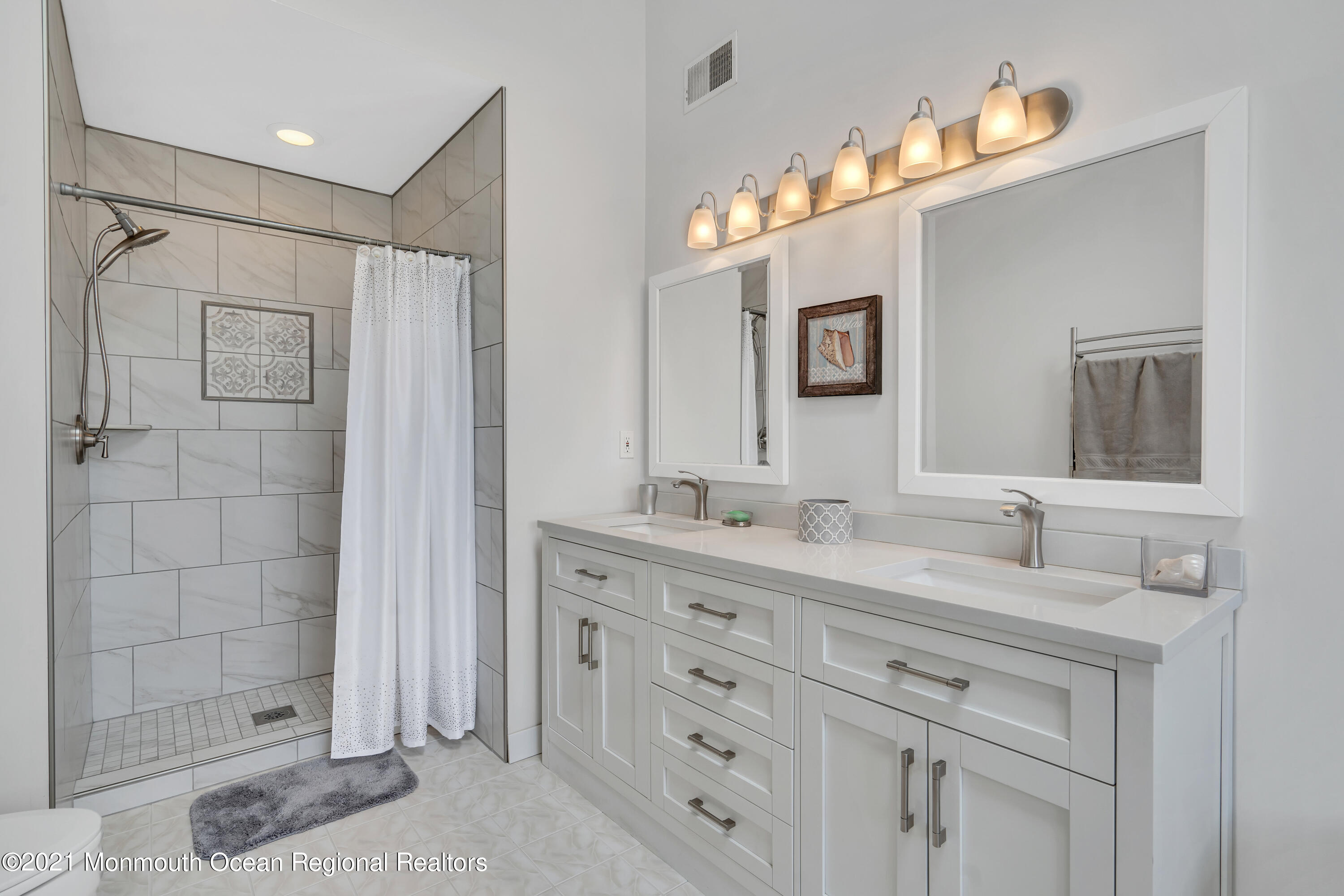 6 Pilot Road Toms River, NJ 08753 - Photo 28 of 35 a bathroom with double vanity sink and a mirror