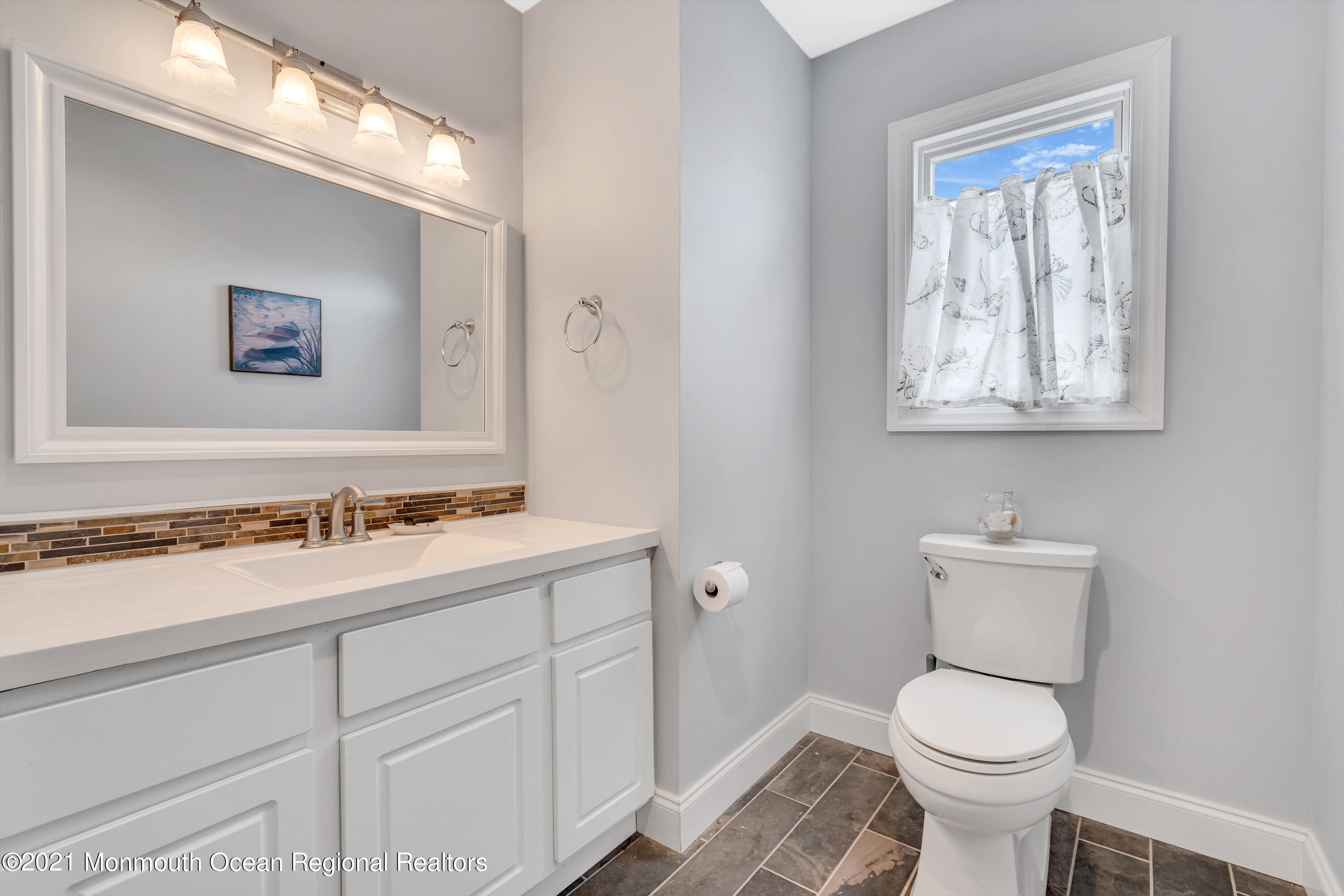 6 Pilot Road Toms River, NJ 08753 - Photo 32 of 35 a bathroom with a toilet sink and mirror