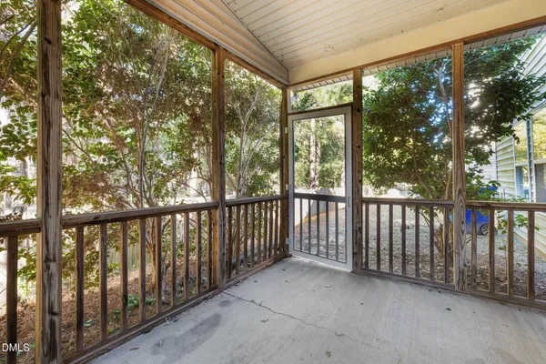 a view of a house with a yard and large tree