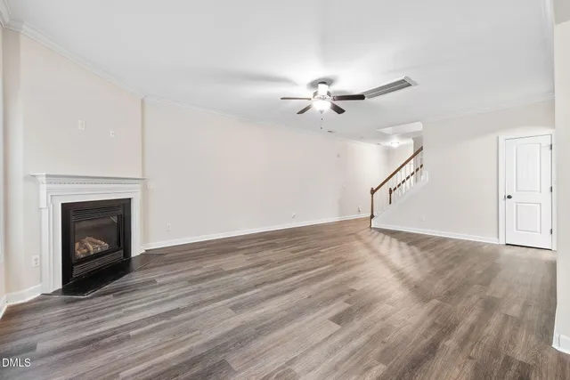 a view of empty room with wooden floor and fireplace