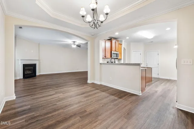 a view of a kitchen with wooden floor and a kitchen space