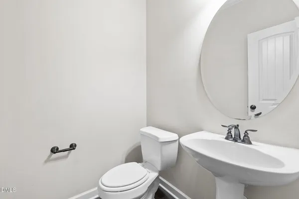 a white toilet sitting next to a bathroom sink