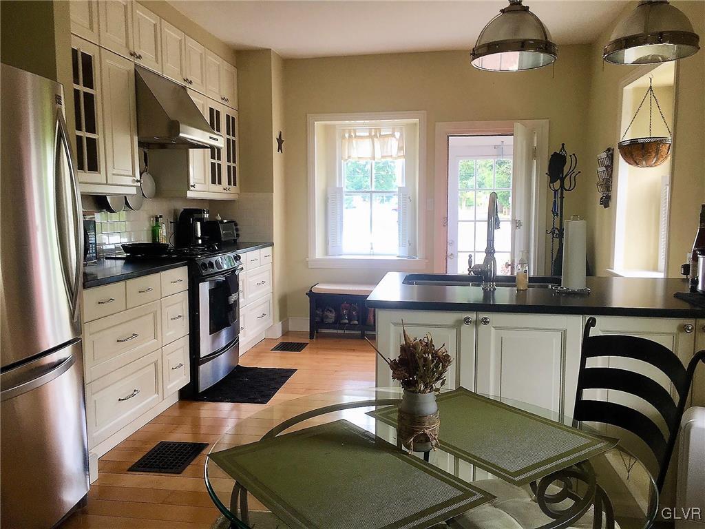 684 Church Road Riegelsville, PA 18077 - Photo 4 of 37 a kitchen with stainless steel appliances granite countertop a stove a sink and a refrigerator
