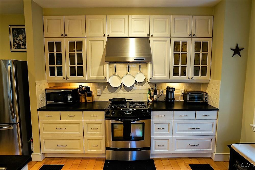 684 Church Road Riegelsville, PA 18077 - Photo 5 of 37 a kitchen with stainless steel appliances a stove and a refrigerator