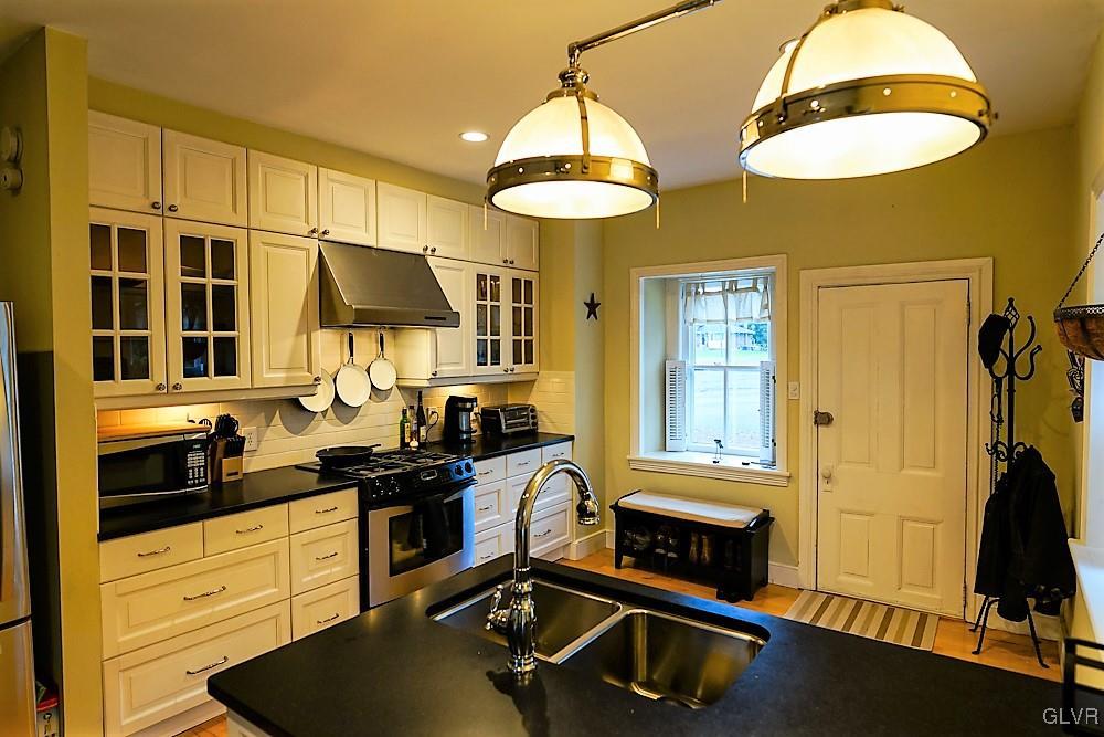 684 Church Road Riegelsville, PA 18077 - Photo 7 of 37 a kitchen with stainless steel appliances a stove a sink and a refrigerator