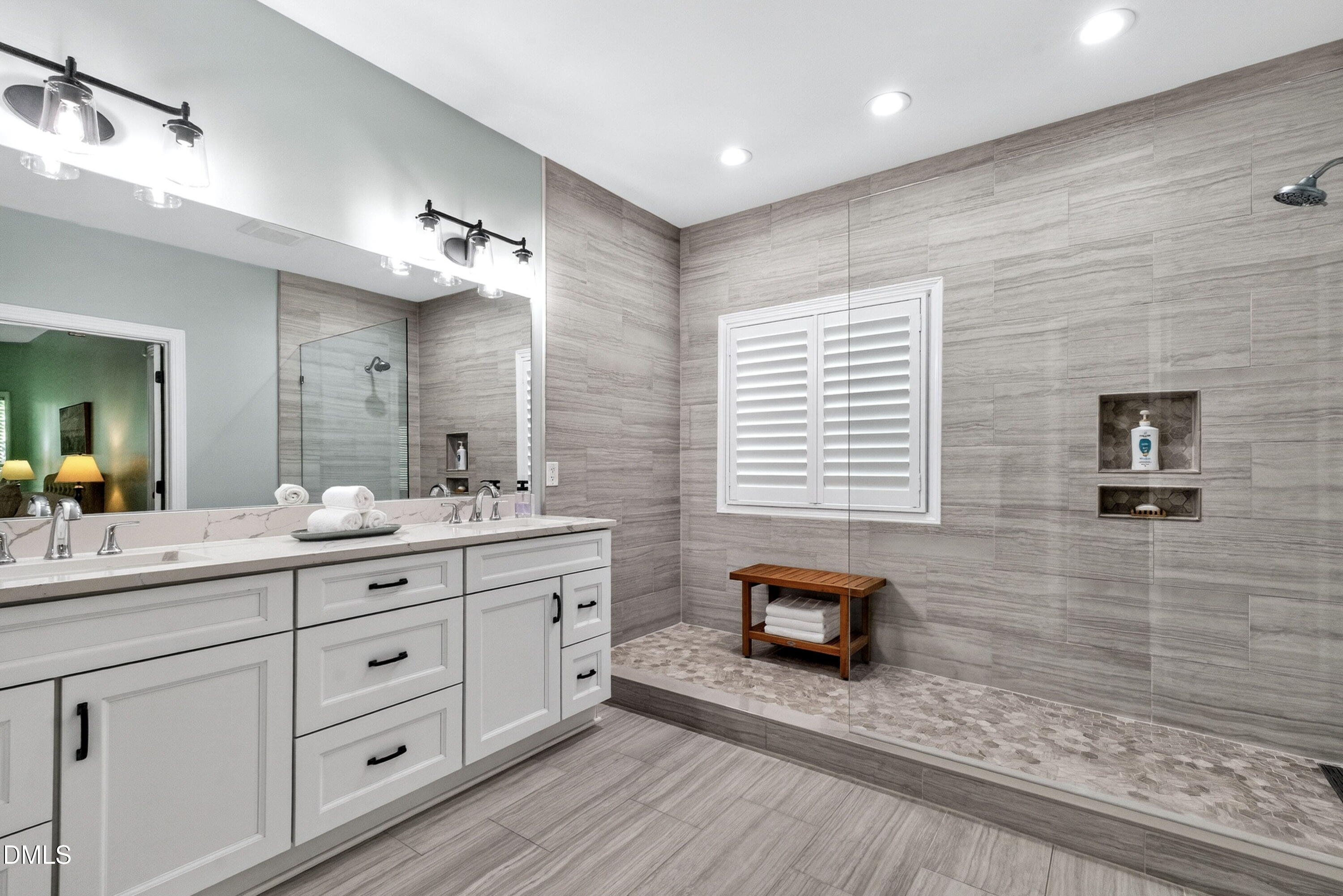 6329 Battleview Drive Raleigh, NC 27613 - Photo 19 of 36 a bathroom with double sink and a mirror
