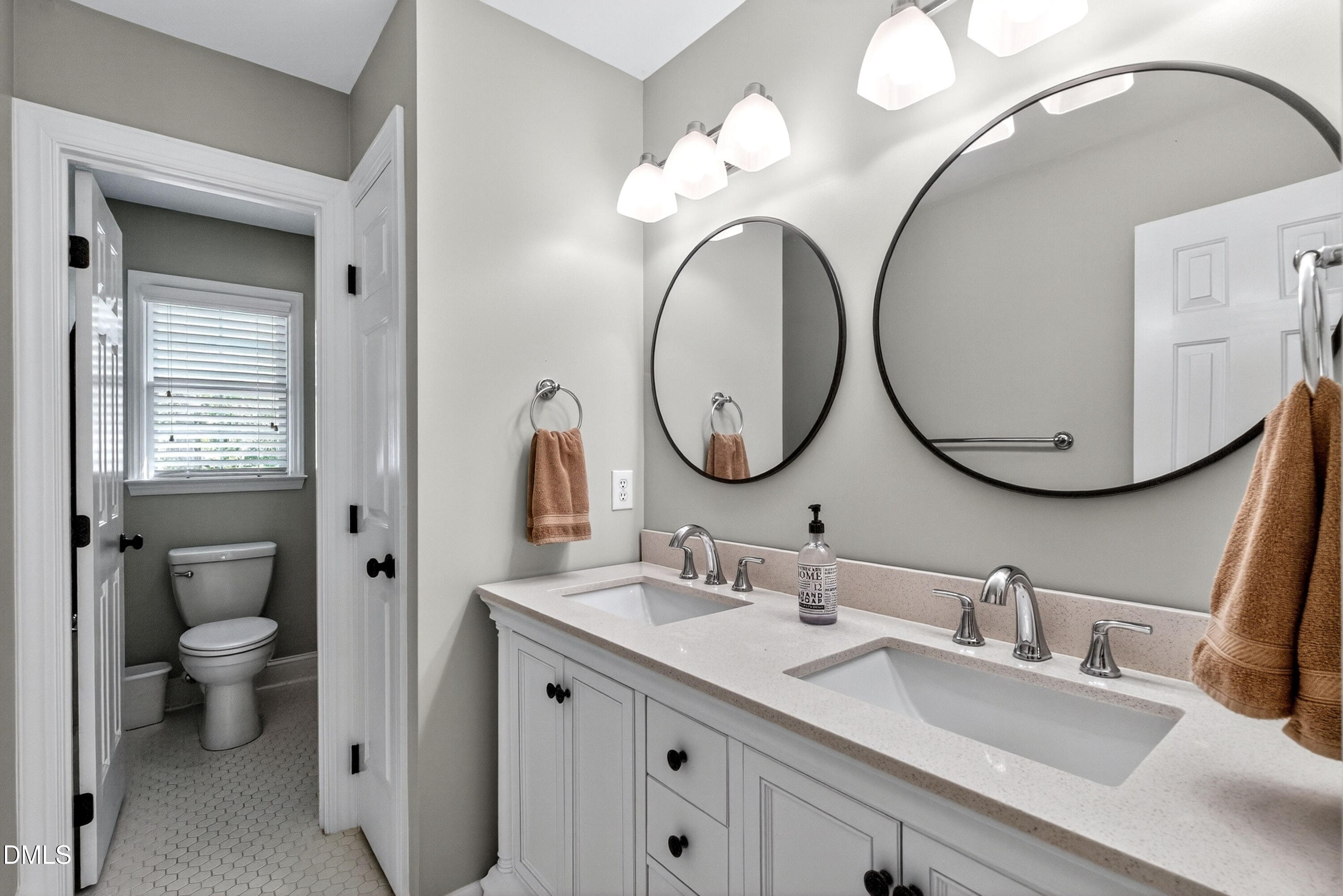6329 Battleview Drive Raleigh, NC 27613 - Photo 24 of 36 a bathroom with a granite countertop double vanity sink and a mirror