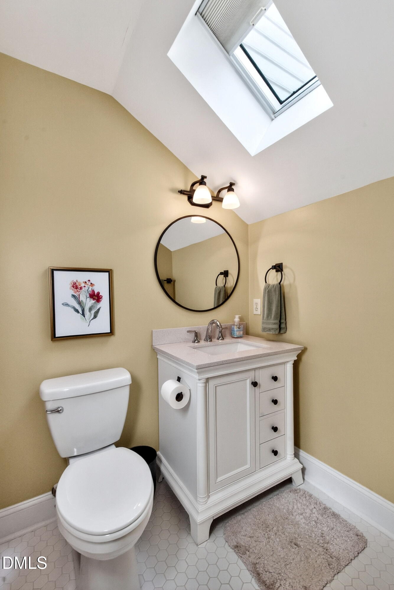 6329 Battleview Drive Raleigh, NC 27613 - Photo 28 of 36 a bathroom with a toilet a sink and a mirror
