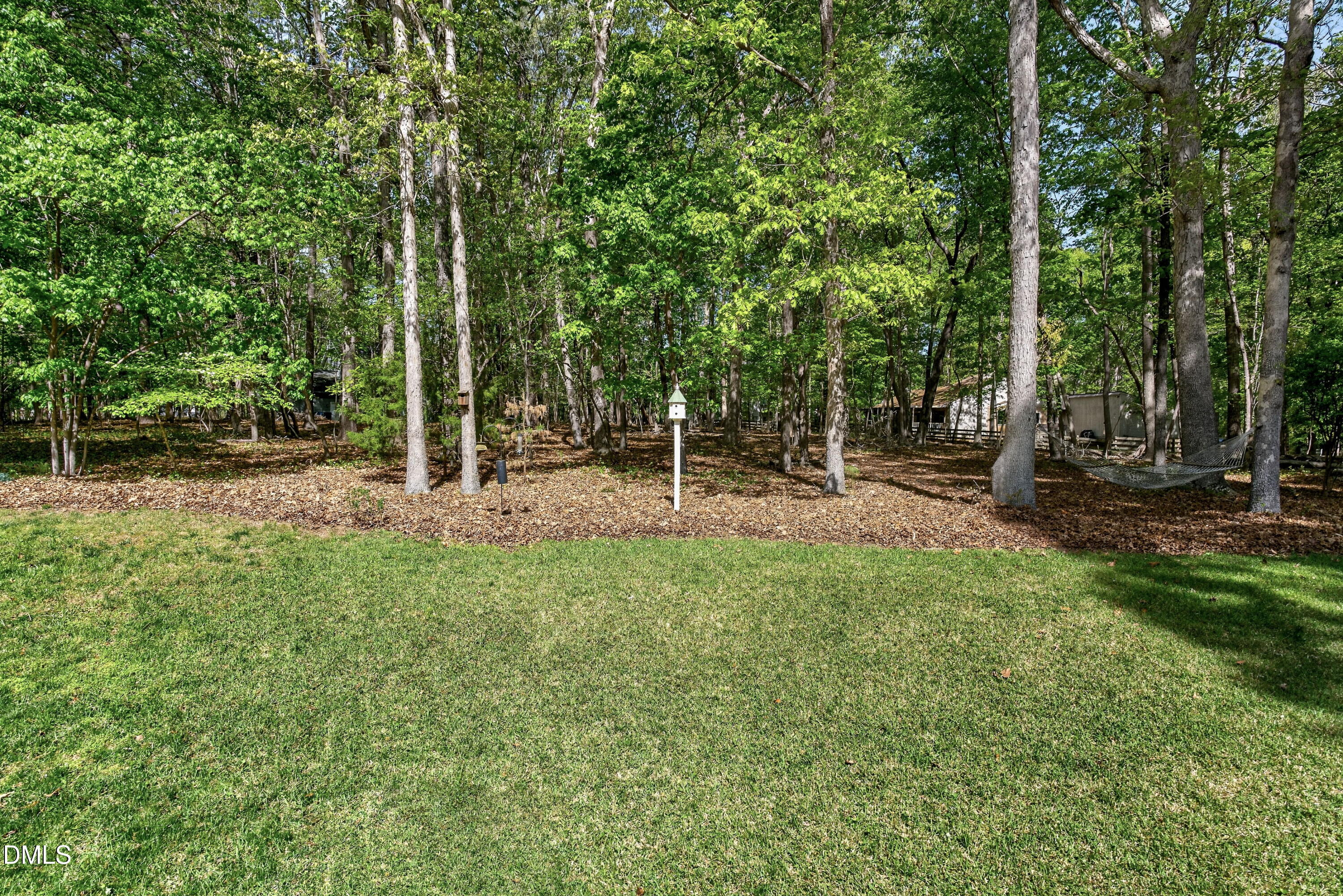 6329 Battleview Drive Raleigh, NC 27613 - Photo 35 of 36 a backyard of a house with lots of green space