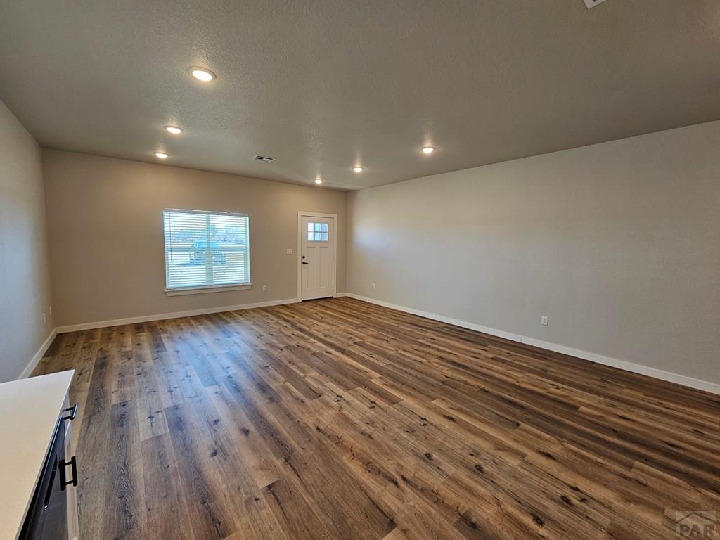 28655 County Road 24.6 Springfield, CO 81073 - Photo 4 of 19 an empty room with wooden floor and windows