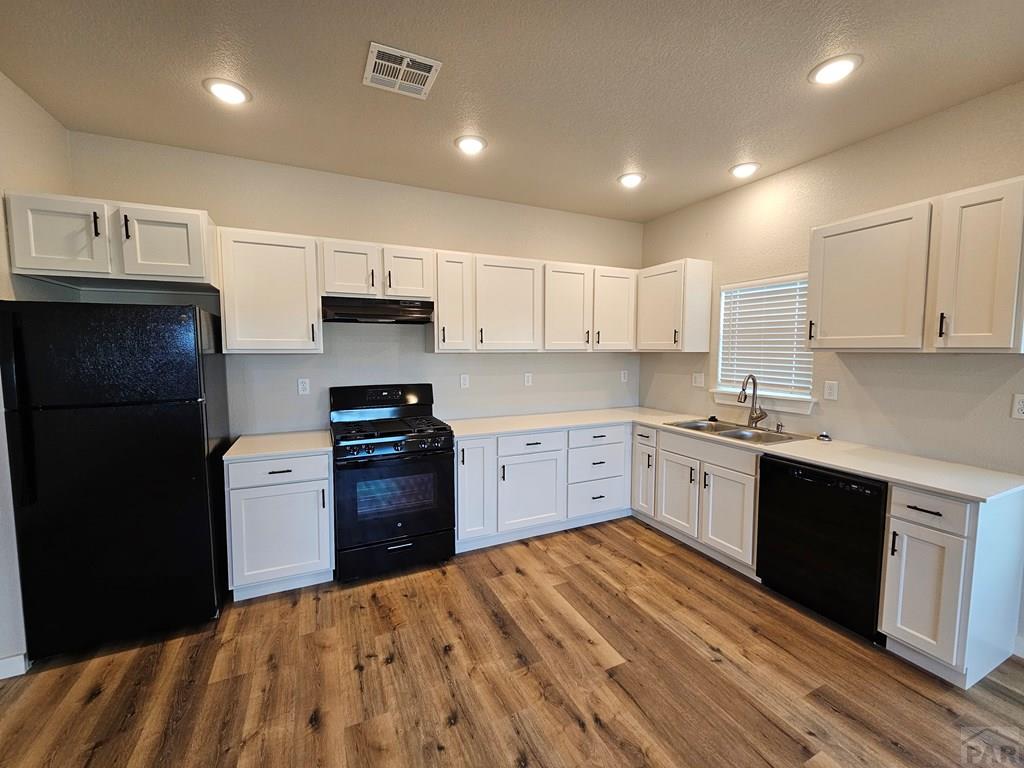 28655 County Road 24.6 Springfield, CO 81073 - Photo 5 of 19 a kitchen with granite countertop a refrigerator stove top oven and wooden floor