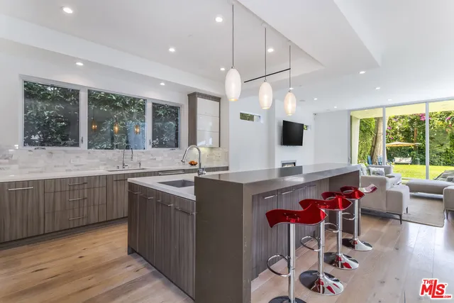 a kitchen with a sink cabinets and wooden floor