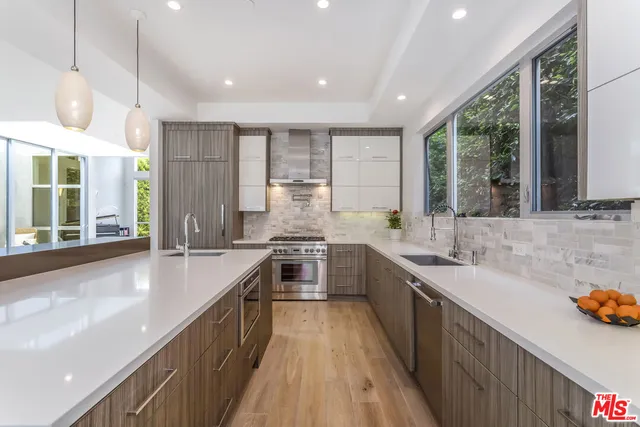 a kitchen with a sink stove and cabinets