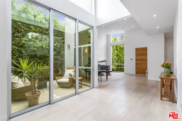 a living room filled with furniture and a potted plant