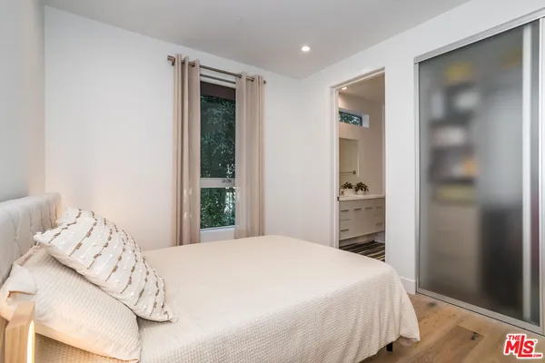 a bedroom with a bed and a mirror