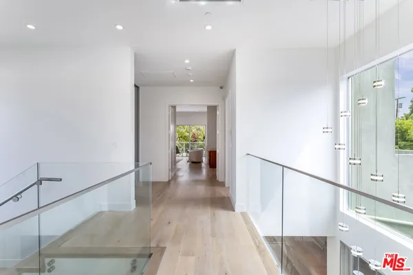 a view of a hallway view with wooden floor and staircase