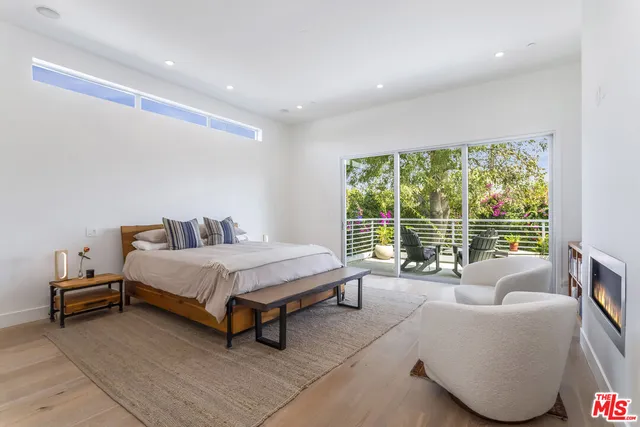 a spacious bedroom with a bed and a large window