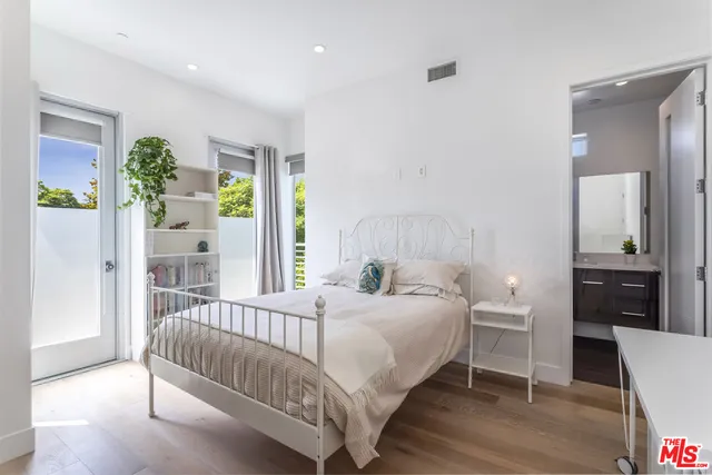 a bathroom with a sink a toilet a mirror a bathtub and shower