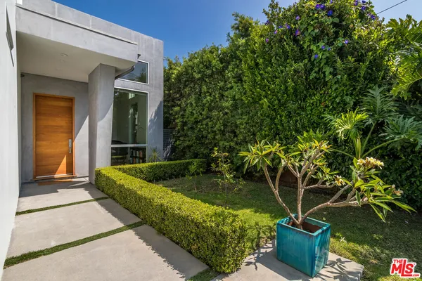 a view of potted plants in front of a house