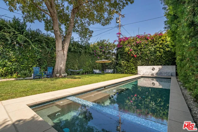 a view of a patio with table and chairs and potted plants