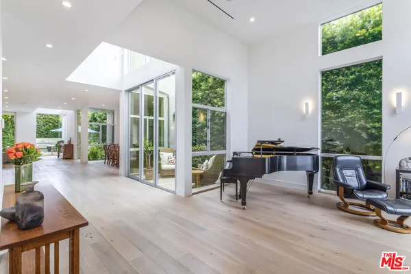 a living room with furniture and a floor to ceiling window