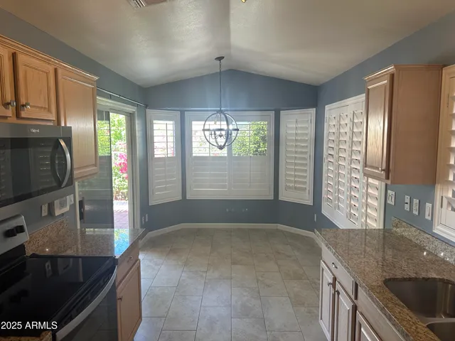 a stove top oven sitting inside of a kitchen