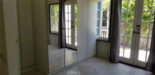 a view of hallway with furniture and wooden floor