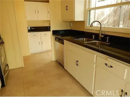 a stove top oven sitting inside of a kitchen
