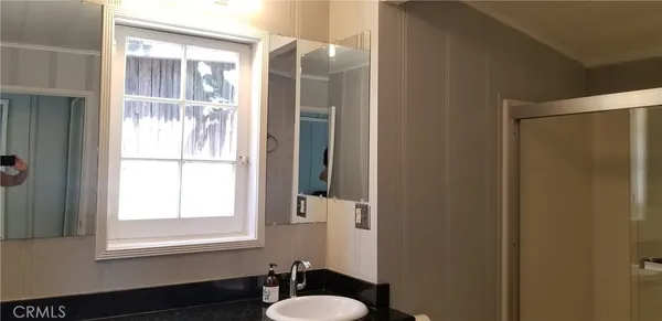 a wooden bench sitting in the middle of a yard