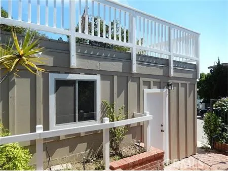 a view of balcony with furniture