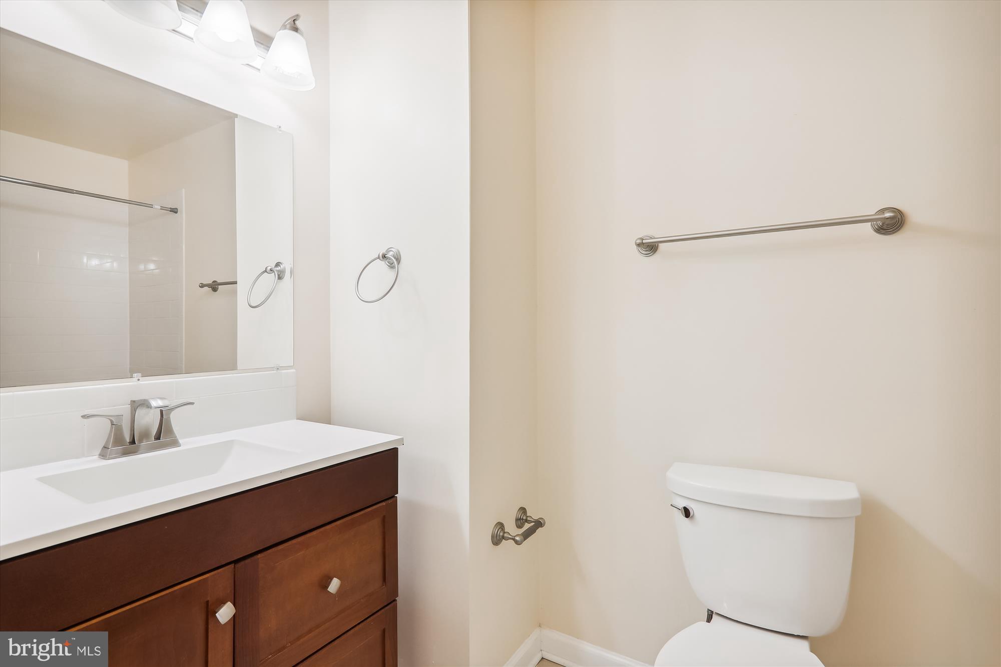 13164 Musicmaster Drive, Unit 144 Silver Spring, MD 20904 - Photo 12 of 31 a bathroom with a sink a toilet and shower