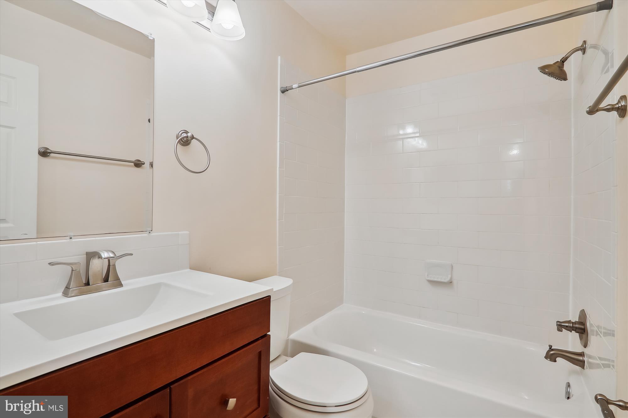13164 Musicmaster Drive, Unit 144 Silver Spring, MD 20904 - Photo 16 of 31 a bathroom with a sink toilet vanity and shower