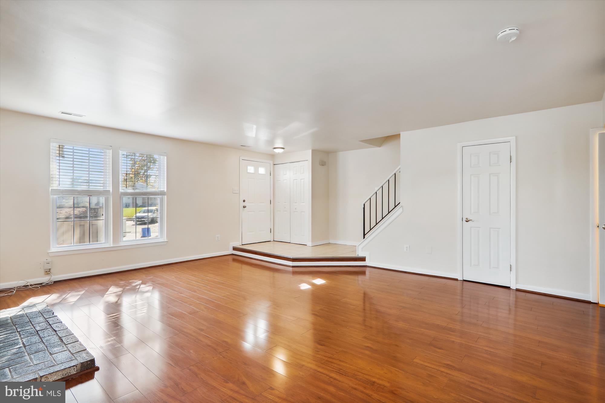 13164 Musicmaster Drive, Unit 144 Silver Spring, MD 20904 - Photo 2 of 31 a view of an empty room with wooden floor and a window