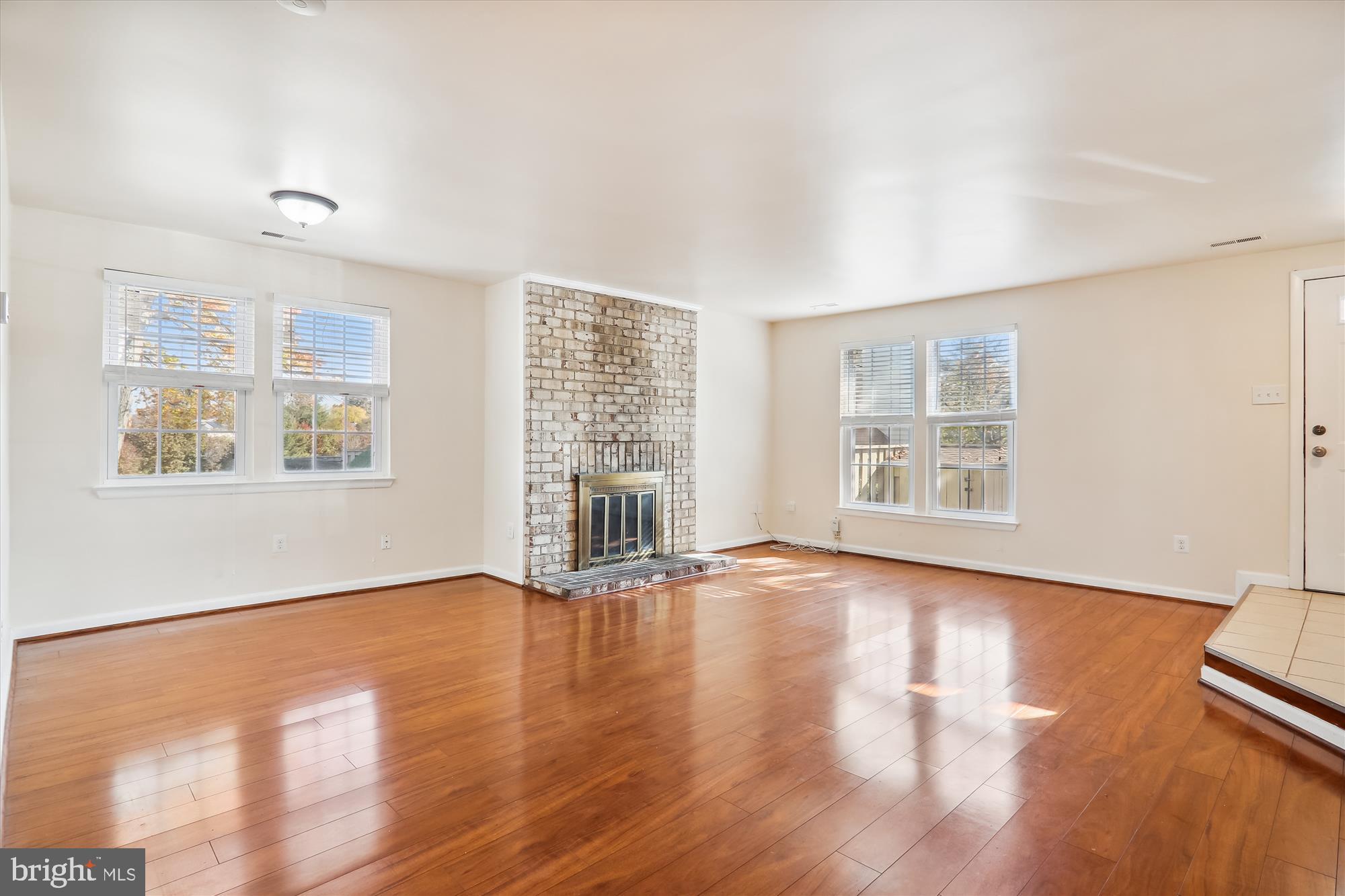 13164 Musicmaster Drive, Unit 144 Silver Spring, MD 20904 - Photo 3 of 31 wooden floor in an empty room with a window