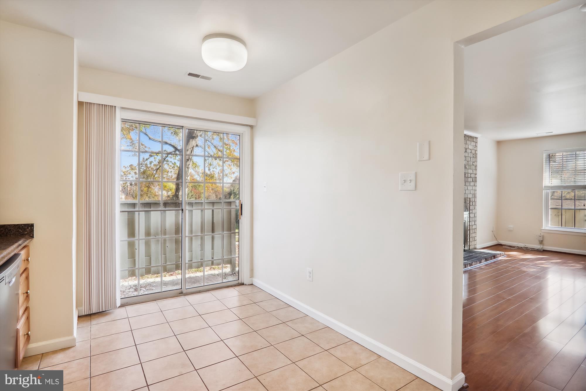 13164 Musicmaster Drive, Unit 144 Silver Spring, MD 20904 - Photo 8 of 31 a view of an empty room with wooden floor and a window