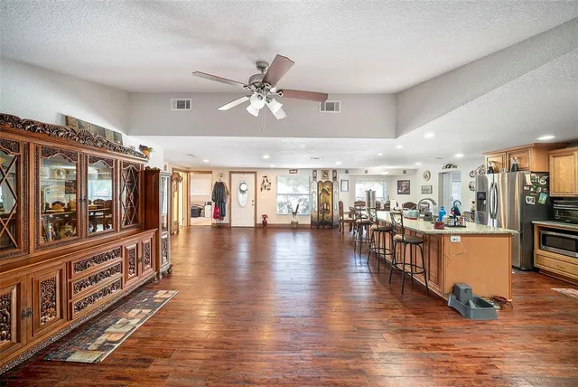 a view of a living room and kitchen with a large window
