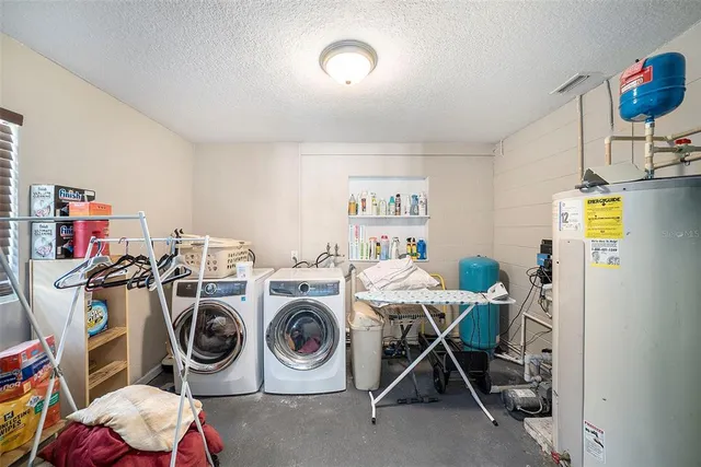 a utility room with dryer washer and other items