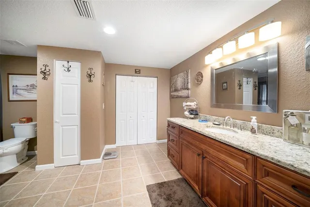 a spacious bathroom with a granite countertop sink mirror and a