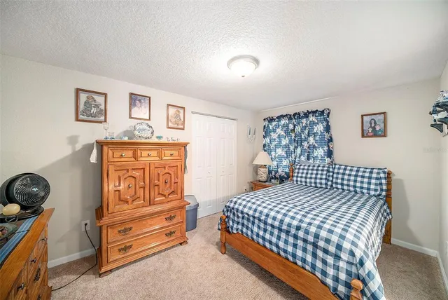 a bedroom with a bed and cabinets