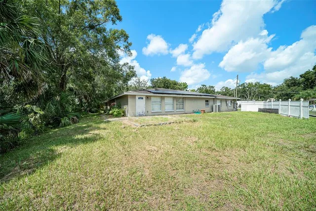 a front view of house with yard and green space