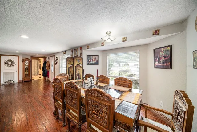 a view of a livingroom with furniture hardwood floor and workspace